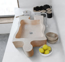 Beige Travertine puzzle shape farmhouse sink NTRVS02 W16 L27.5 kitchen installed above counter lemons on the white bowl