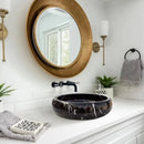 Toros Black Marble Above Vanity Bathroom Vessel Sink Polished (D)16" (H)5" installed bathroom above marble vanity very big round gold color mirror and wall mount lamps along with black wall mount faucet liquid soap dispenser gray hand towel on vanity and hung on wall