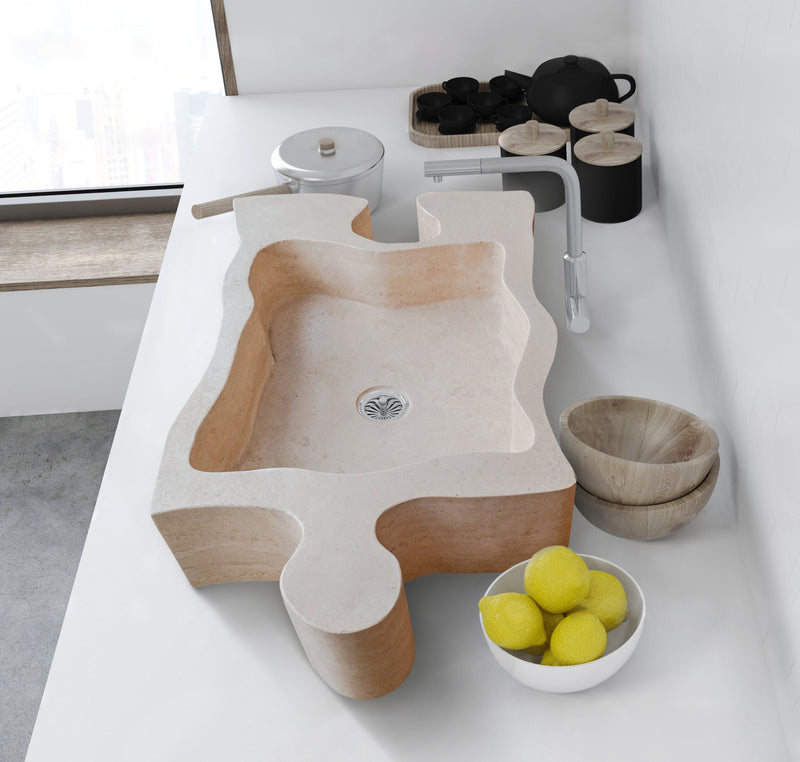 Beige Travertine puzzle shape farmhouse sink NTRVS02 W16 L27.5 kitchen installed above counter lemons on the white bowl 