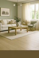 Living room with a beige sofa, wooden coffee table, and a window with curtains.