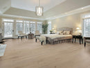 Spacious bedroom with large windows, bed, and sitting area. K-09VH