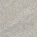 Close-up of a textured stone surface with a neutral color palette.