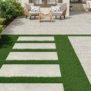 Outdoor patio with chairs, table, and stone steps leading to a grassy area.