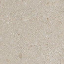 Close-up of beige sand with small stones