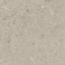 Close-up of a beige stone surface with subtle variations in color.