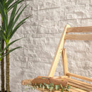 Wooden basket with eucalyptus leaves against a textured wall.