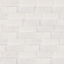 Pattern of light gray tiles arranged in a herringbone style.
