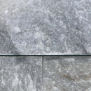 Close-up of gray stone tiles with a visible joint.