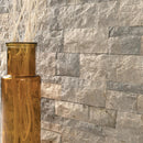Gold vase against a stone wall
