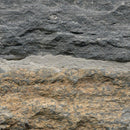 Close-up of a stone wall with varying shades of gray and brown.