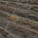Close-up of a stone wall with varying stone sizes and colors.
