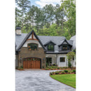 Stately house with a driveway and greenery