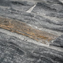 Close-up of a stone surface with a focus on texture and color variation.