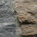 Close-up of a stone wall with gray and brown stones