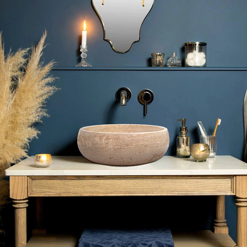 Light Beige Travertine Natural Stone Above Vanity Bathroom Vessel Sink Polished installed inside bathroom above vanity blue background and wall mount faucets in gold color