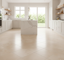 Modern kitchen with white cabinets, marble island, and large windows.