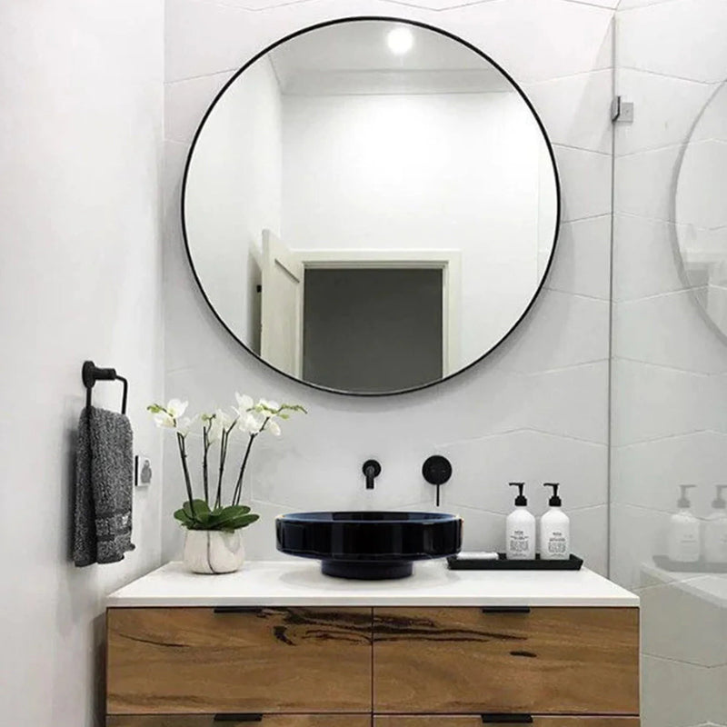 Toros Black Marble Above Vanity Designer Bathroom Sink Middle Drain Cap (D)16" (H)6" installed bathroom with big round mirror on the wall and flower on the vanity and wall-hung gray hand-towel on left side