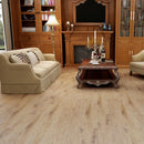 Rigid core vinyl planks 7x48 SPC greek islands beige 5.2mm 12mil wear layer 1520517 installed on a traditional living room floor. Red wine and 2 glasses on table with candles
