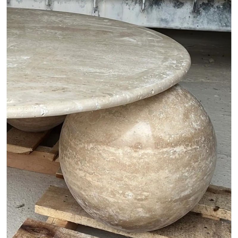 Round designer coffee table travertine filled polished D36 3 sphere legs close-up