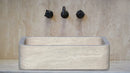 Troia Light Travertine Rectangular Farmhouse Kitchen Sink (W)18" (L)27.5" (H)7" bathroom view with black 8" widespread wall-mounted faucet
