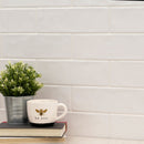 Urbano pure ceramic white subway tile 4x12 glossy  msi collection NURBPUR4X12 room shot table view 2
