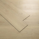 Close-up of beige wooden flooring with a single plank partially lifted.