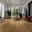Modern living room with wooden flooring, furniture, and large windows.