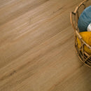 Wooden floor with a wicker basket containing colorful cushions.