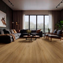 Modern living room with wooden flooring, gray sectional sofa, and large windows.