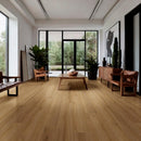 Modern living room with wooden flooring, furniture, and large windows.