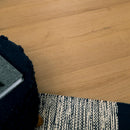 Close-up of a textured black and white rug on a wooden floor