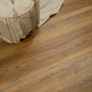 Wooden flooring with a gold basket and white towels in the background