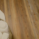 Wooden floor with a basket of white towels on a wooden surface