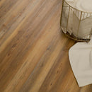 Wooden floor with a gold wire basket and white cushion in the corner.