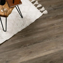 Wooden flooring with a white rug and decorative items.
