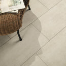 Wicker chair with a newspaper on a tiled floor