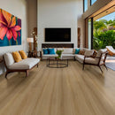 Modern living room with wooden flooring, furniture, and large windows.
