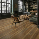 Modern living room with wooden floor, bookshelves, and furniture.