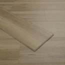 Wooden flooring with a plank being lifted to show texture