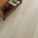 Wooden shoe rack with shoes on a tiled floor