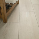 Wooden floor with a wooden bench and shoes in the background