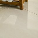 Close-up of a tiled floor with a wooden bench in the background