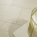 Beige tiles with a gold decorative item on a light beige floor