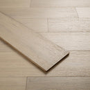 Close-up of a wooden floor with a herringbone pattern