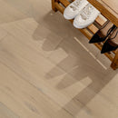 Wooden floor with a bench and shoes in the background