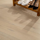 Wooden floor with a wooden shoe rack holding shoes.