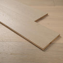 Close-up of a wooden flooring panel on a matching floor.