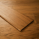 Wooden flooring with a plank partially overlapped on a wooden floor.