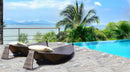 Alaska Silver Travertine Pattern Tumbled Pavers - Full Truckload ocean view next to swimming pool 2 modern rattan brown sunbeds 