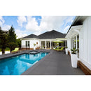 blue stone porcelain pavers 24x24in matte floor tile LPAVNBLUSTO2424 installed around swimming pool on backyard of a nice house